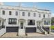 Charming white brick townhome featuring a black garage and a welcoming front entrance with staircase at 3667 Peachtree Ne Rd # 6, Atlanta, GA 30319