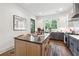 Spacious kitchen showcasing a large island, stainless steel appliances, modern cabinetry, and convenient access to outdoor spaces at 3667 Peachtree Ne Rd # 6, Atlanta, GA 30319