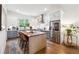Contemporary kitchen features an island with seating, stainless steel appliances, bright white and grey cabinetry, and backyard views at 3667 Peachtree Ne Rd # 6, Atlanta, GA 30319