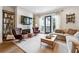 Cozy living room boasts a fireplace with a mounted TV, stylish furnishings, and ample natural light at 3667 Peachtree Ne Rd # 6, Atlanta, GA 30319