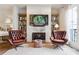 Elegant living room with a fireplace, bookshelves, and comfortable seating, creating a welcoming space at 3667 Peachtree Ne Rd # 6, Atlanta, GA 30319