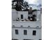 Stylish rooftop patio with lounge seating, a TV, and decorative string lights for outdoor entertainment at 3667 Peachtree Ne Rd # 6, Atlanta, GA 30319