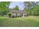 View of the backyard with a shed and a partial view of the house at 7112 Greenway Sw Cv, Covington, GA 30014