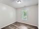 This bedroom features a window and a modern gray-toned laminate floor at 7112 Greenway Sw Cv, Covington, GA 30014
