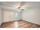 Bright bedroom with modern flooring, a ceiling fan, and a window at 7112 Greenway Sw Cv, Covington, GA 30014