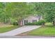 Charming single-story home with a cozy front yard and driveway at 7112 Greenway Sw Cv, Covington, GA 30014