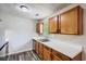 Kitchen featuring wooden cabinetry, stainless steel sink, and gray plank flooring at 7112 Greenway Sw Cv, Covington, GA 30014