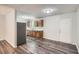 Bright, open kitchen with stainless steel appliances and laminate floors at 7112 Greenway Sw Cv, Covington, GA 30014