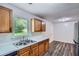 Kitchen area featuring modern appliances, wood cabinets, and a view of the backyard through the window at 7112 Greenway Sw Cv, Covington, GA 30014