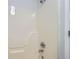 Bathroom shower stall with white surround, chrome faucet and showerhead at 7112 Greenway Sw Cv, Covington, GA 30014