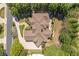 Aerial view showcasing the property's layout, lush landscaping, and surrounding neighborhood at 8715 Islesworth Ct, Duluth, GA 30097