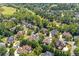Beautiful aerial view of a neighborhood with well-maintained homes, lush greenery, and a golf course in the distance at 8715 Islesworth Ct, Duluth, GA 30097