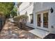 Backyard access through double doors with well-manicured landscaping and stone pathway at 8715 Islesworth Ct, Duluth, GA 30097