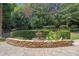 Beautiful backyard fountain surrounded by manicured hedges and stone pavers at 8715 Islesworth Ct, Duluth, GA 30097