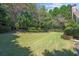 Wide backyard with beautiful grass, mature trees and landscaping at 8715 Islesworth Ct, Duluth, GA 30097