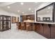 Custom bar area with granite countertops, display cabinets and seating at 8715 Islesworth Ct, Duluth, GA 30097