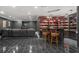 Finished basement with black tile flooring, black bar and black leather sofa at 8715 Islesworth Ct, Duluth, GA 30097