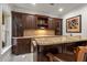 Close up view of the bar with granite countertops, tile backsplash, and bar seating at 8715 Islesworth Ct, Duluth, GA 30097