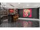 Basement bar area with custom wine storage, dark cabinetry, and modern lighting at 8715 Islesworth Ct, Duluth, GA 30097