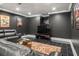 Cozy basement with black walls, tile flooring, recessed lighting, and comfortable seating at 8715 Islesworth Ct, Duluth, GA 30097