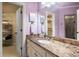 Stylish bathroom boasts granite countertop vanity, and convenient access to a walk-in closet at 8715 Islesworth Ct, Duluth, GA 30097
