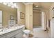 Bright bathroom features a granite vanity, white cabinetry, and a combined shower and tub at 8715 Islesworth Ct, Duluth, GA 30097