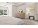 Bright bedroom featuring a window seat, dresser, and a desk with ample natural light at 8715 Islesworth Ct, Duluth, GA 30097