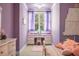 Charming bedroom boasts a window desk nook, lilac walls, and whimsical decor at 8715 Islesworth Ct, Duluth, GA 30097