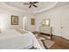 Light and bright bedroom featuring a tray ceiling, wood floors, and an elegant mirrored dresser at 8715 Islesworth Ct, Duluth, GA 30097