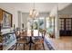 Formal dining room featuring a large window, beautiful chandelier, and elegant decor at 8715 Islesworth Ct, Duluth, GA 30097