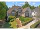 Inviting exterior of a stone and siding home featuring a manicured lawn and well-maintained landscaping at 8715 Islesworth Ct, Duluth, GA 30097