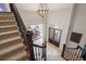 Elegant foyer with stairway leading to dining room and front entry at 8715 Islesworth Ct, Duluth, GA 30097