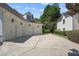 Three-car garage with a long driveway and clean landscaping at 8715 Islesworth Ct, Duluth, GA 30097