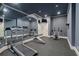 At-home gym with treadmill, weight rack, and mirrors at 8715 Islesworth Ct, Duluth, GA 30097