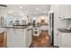 A gourmet kitchen boasts an island, stainless steel appliances, and custom white cabinetry at 8715 Islesworth Ct, Duluth, GA 30097