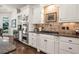 A kitchen showcases stainless steel appliances, granite counters, and custom white cabinets at 8715 Islesworth Ct, Duluth, GA 30097