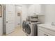 A well-lit laundry room offers modern appliances, ample storage, and utility sink at 8715 Islesworth Ct, Duluth, GA 30097