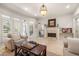 Cozy living room with a fireplace, plush seating, and natural light from large windows at 8715 Islesworth Ct, Duluth, GA 30097