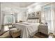 A bright main bedroom features a tray ceiling, natural light, and an attached seating area at 8715 Islesworth Ct, Duluth, GA 30097