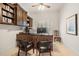 At-home office with built-in shelves, black desk and two chairs at 8715 Islesworth Ct, Duluth, GA 30097