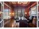 A sophisticated office showcases wood paneling, built-in bookshelves, and coffered ceilings at 8715 Islesworth Ct, Duluth, GA 30097