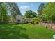 Lush green backyard showcases the home's exterior, complemented by mature trees, offering a private retreat at 151 Grandma Branch Rd, Grantville, GA 30220