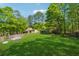Large backyard features a playground, tool shed, and ample space for outdoor activities and relaxation at 151 Grandma Branch Rd, Grantville, GA 30220