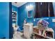 Blue bathroom featuring a single sink vanity, toilet and an open shelf for towels and other items at 151 Grandma Branch Rd, Grantville, GA 30220