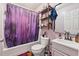 Bathroom featuring a tub with shower, vanity with sink and open shelves at 151 Grandma Branch Rd, Grantville, GA 30220
