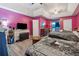 Bedroom featuring two beds, hardwood floors, and a purple painted wall at 151 Grandma Branch Rd, Grantville, GA 30220