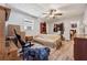 The bedroom features hard surface flooring, neutral walls, a ceiling fan and ensuite bath at 151 Grandma Branch Rd, Grantville, GA 30220