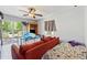 This bedroom features an ensuite bath, a ceiling fan, wood-look floors, and access to a private deck at 151 Grandma Branch Rd, Grantville, GA 30220