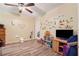 Bedroom with dinosaur decorations, ceiling fan and hard wood floors at 151 Grandma Branch Rd, Grantville, GA 30220