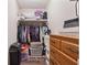 Walk-in closet providing storage with a wooden dresser and clothing rack at 151 Grandma Branch Rd, Grantville, GA 30220